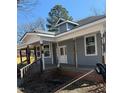Covered porch featuring aged columns and white trim on a charming two-story home at 425 S Mercer St, Rocky Mount, NC 27801