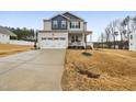 Charming two-story home with a welcoming front porch and a well-manicured lawn at 440 Pierce Landing Dr, Garner, NC 27529