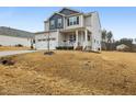 Charming two-story home with a welcoming front porch and a well-manicured lawn at 440 Pierce Landing Dr, Garner, NC 27529