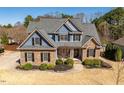 Charming two-story home featuring a combination of stone and blue siding under a roof at 4773 Swordfish Dr, Raleigh, NC 27603