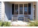 Inviting front porch featuring two rocking chairs and a small table for outdoor relaxation at 4773 Swordfish Dr, Raleigh, NC 27603