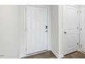 Bright entryway with white door and neutral walls adjacent to the interior garage door at 50 Sweet Meadow Rd, Angier, NC 27501