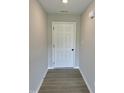 Hallway featuring wood-look flooring and neutral walls at 59 Pagani Dr, Kenly, NC 27542
