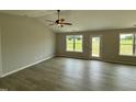 Bright living room with many windows and a ceiling fan at 59 Pagani Dr, Kenly, NC 27542