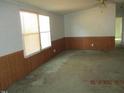 Bright living room with large windows providing natural light and a ceiling fan at 65 Aunt Bibba Way, Youngsville, NC 27596