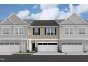 Charming townhouse with stone accents and two-car garage offers a stylish and inviting curb appeal at 6964 Doddridge Ln # 13, Cary, NC 27519