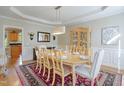 Elegant dining room with decorative rug, china cabinet, and natural light at 704 Walcott Way, Cary, NC 27519