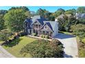 Beautiful home with a long driveway, basketball court and a well-maintained lawn and mature trees at 704 Walcott Way, Cary, NC 27519