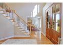 Grand foyer featuring hardwood floors, staircase with decorative wrought iron, and natural light at 704 Walcott Way, Cary, NC 27519