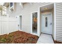 Exterior side entrance featuring white siding, a fenced-in yard, and ample natural light at 7205 Sandy Creek Dr, Raleigh, NC 27615