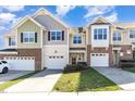 Inviting townhouse exteriors showcasing attached garages and manicured green spaces at 7213 Terregles Dr, Raleigh, NC 27617