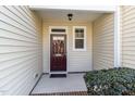 Front entryway with a decorative wreath and well-kept shrubbery at 7213 Terregles Dr, Raleigh, NC 27617