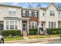 Charming townhome featuring a brick facade, black shutters, and a well-manicured front yard at 7753 Winners Edge St, Raleigh, NC 27617