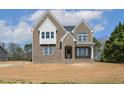 Beautiful two-story brick home with detailed windows and a welcoming covered entrance at 9000 Penny Rd, Raleigh, NC 27606