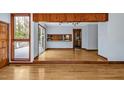 Open-concept living area featuring hardwood floors, wood accents, and plenty of natural light at 100 Pebble Ct, Chapel Hill, NC 27516