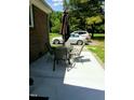 Outdoor patio with seating and an umbrella provides a relaxed entertaining space at 103 Crestwater Ct, Louisburg, NC 27549
