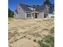 New two-story home with gray siding, covered front porch and attached garage at 1039 N Lincoln St, Benson, NC 27504