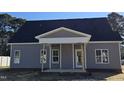 Charming gray home with a covered front porch and classic architectural details at 1039 N Lincoln St, Benson, NC 27504