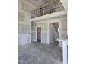 View of a large living room with a cathedral ceiling and access to the staircase and second level at 1039 N Lincoln St, Benson, NC 27504