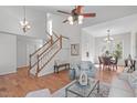 Spacious living room with a staircase and open to a dining area at 109 Covington Square Dr, Cary, NC 27513