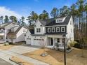 Inviting two-story home featuring a three-car garage and a welcoming front porch at 110 Jacoby Way, Chapel Hill, NC 27516