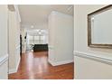 Hallway featuring wood floors and white trim opens to living area at 117 Oak Rise Ln, Fuquay Varina, NC 27526