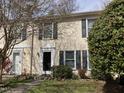 Charming townhouse featuring black shutters, manicured landscaping and a lush, green lawn at 12 Patriot Cir, Durham, NC 27704