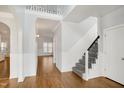 Bright entryway showcasing hardwood floors, wainscoting, staircase, and arched doorway at 121 Homegate Cir, Apex, NC 27502