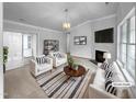 Bright, modern living room with stylish furniture, fireplace, and neutral color palette at 1213 Cotten Farm Dr, Fuquay Varina, NC 27526
