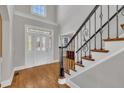 Grand foyer with soaring ceilings, hardwood floors, and decorative staircase at 12404 Beauvoir St, Raleigh, NC 27614