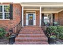 Inviting brick front porch and leaded glass door, complete with seasonal wreath at 12404 Beauvoir St, Raleigh, NC 27614