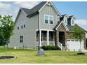 Charming two-story home with a combination of stone and siding with a manicured lawn at 125 Scotland Dr, Youngsville, NC 27596