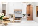 Modern kitchen featuring white cabinets, marble countertops, and stainless steel appliances for a sleek design at 1512 Clark Farm Rd, Apex, NC 27502