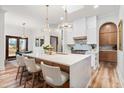 Bright kitchen featuring a large island, stylish pendant lighting, and modern appliances for cooking enthusiasts at 1512 Clark Farm Rd, Apex, NC 27502