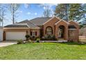 Charming single story brick home with attached garage and manicured lawn at 199 Black Cloud Dr, Louisburg, NC 27549