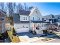 Beautiful two-story house with a front porch, attached garage, well-maintained lawn, and lovely landscaping at 201 Bluffwood Avenue, Chapel Hill, NC 27516