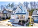 Inviting two-story home featuring a covered front porch and an attached garage with driveway at 201 Bluffwood Avenue, Chapel Hill, NC 27516
