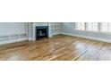 Open living room showcases hardwood floors, a fireplace, built-in shelving, and natural light at 201 Bluffwood Avenue, Chapel Hill, NC 27516