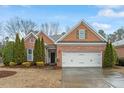 Charming single-story brick home with a two-car garage and well-maintained lawn at 201 Hales Wood Rd, Chapel Hill, NC 27517