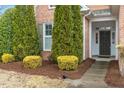 Inviting front entrance with a well-manicured garden and covered porch at 201 Hales Wood Rd, Chapel Hill, NC 27517