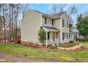 Charming two-story townhome with a welcoming front porch and well-manicured lawn at 226 Bracken Ct, Raleigh, NC 27615