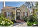 Charming home with a well-manicured lawn, brick entrance and colorful shutters at 2401 Englewood Ave, Durham, NC 27705