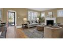 Bright and spacious living room with fireplace, comfortable seating, and hardwood floors at 2401 Englewood Ave, Durham, NC 27705