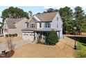 Charming two-story home with stone accents, a covered porch, and well-manicured landscaping at 253 Bendemeer Ln, Rolesville, NC 27571