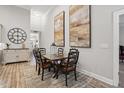 Elegant dining area with a wood table, stylish rug, and decorative wall art at 255 Thornwhistle Pl, Garner, NC 27529
