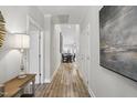 Bright hallway with hardwood floors leads to the dining area, enhancing the home's flow at 255 Thornwhistle Pl, Garner, NC 27529