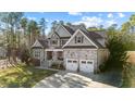 Attractive two-story home with a stone-accented facade, covered porch, and convenient two-car garage at 260 Crestdale Dr, Clayton, NC 27520