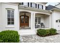 Inviting front porch with double doors, chairs, and stone walkway at 2635 Lakeview Dr, Raleigh, NC 27609