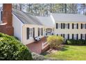 Charming home featuring a brick walkway, a cozy bench, manicured shrubs, and a well-kept lawn at 3508 Cambridge Rd, Durham, NC 27707