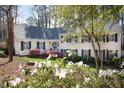 Inviting two-story home with lush landscaping, mature trees, and a well-manicured lawn at 3508 Cambridge Rd, Durham, NC 27707